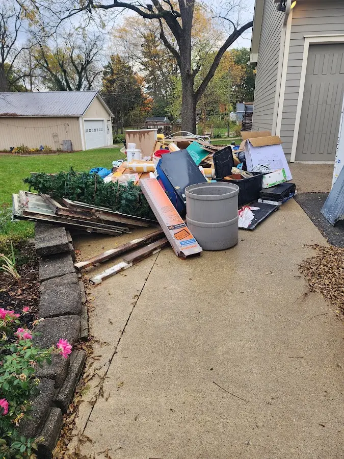 Dumpster being loaded with debris for Roofing Dumpster Rental in Watertown